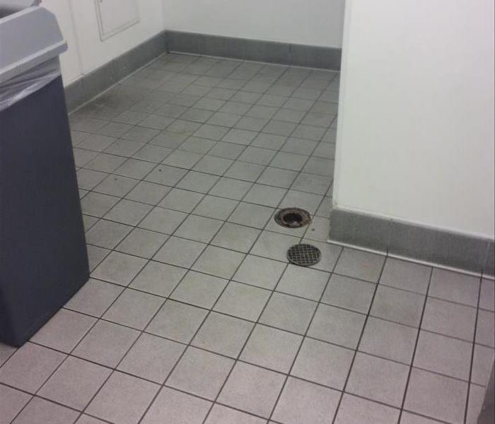Clean sterilized white tile floor in bathroom