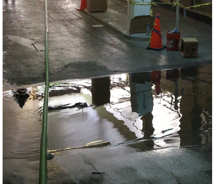 pools of water in the lower level of a concrete parking lot