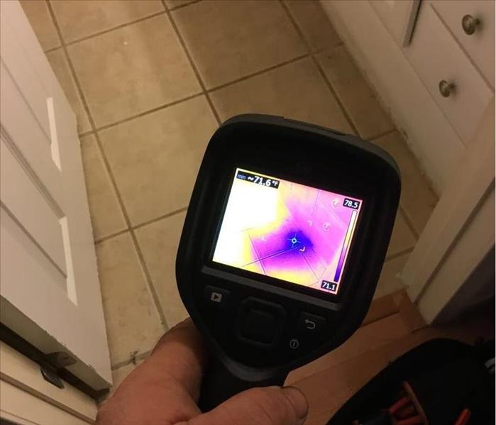 A thermal imaging camera finding excess moisture in a customers home before mitigation