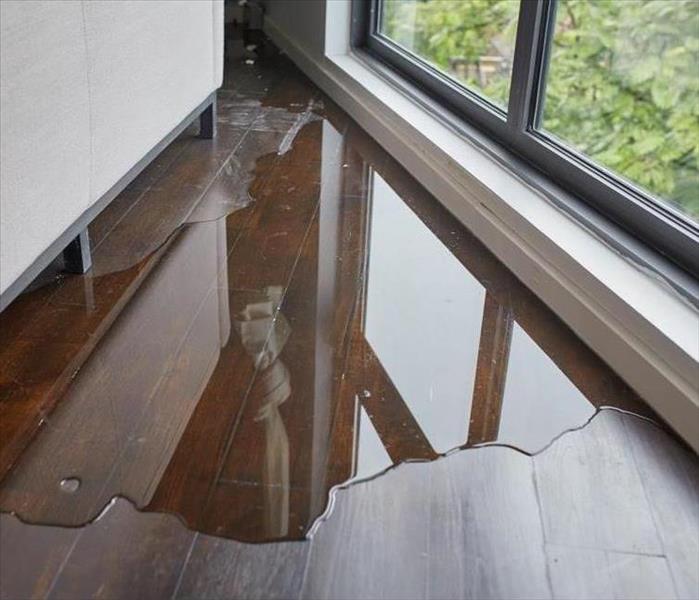 A puddle of water collecting inside a building 